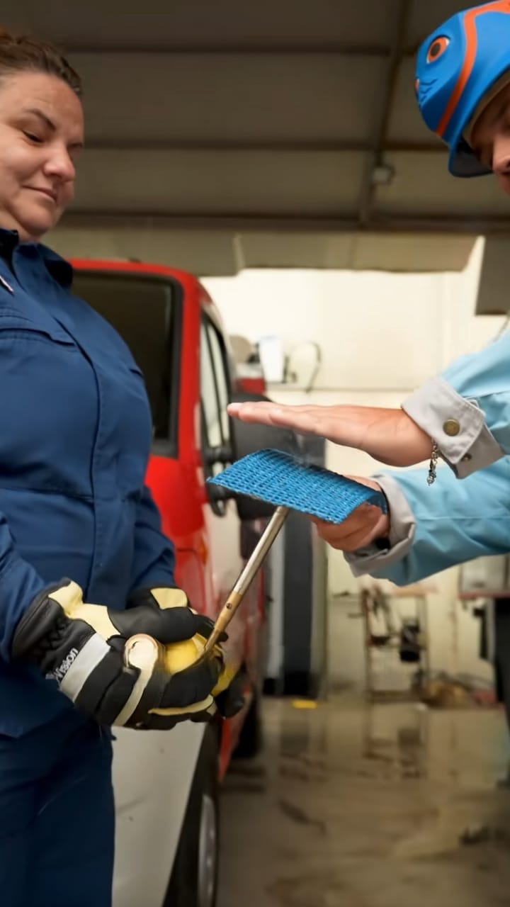 Firefighter in a fire station holding a piece of INCA WFS net® while it is demonstrated to her