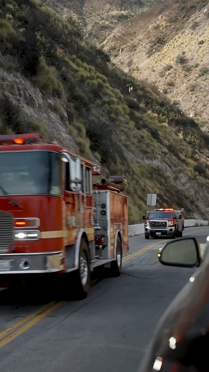 Fire engine on a narrow road through a canyon